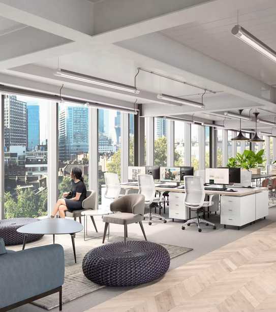 Woman in office space looking out the window
